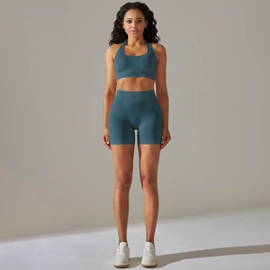 Detail of teal ribbed seamless yoga set showing halter neck top and high waist shorts