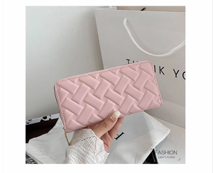 Detail of pink quilted long wallet with elegant diamond texture and zip closure