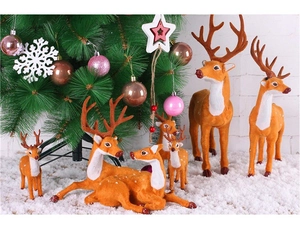 Detailed view of assorted reindeer figurines with realistic flocking texture in Christmas setting