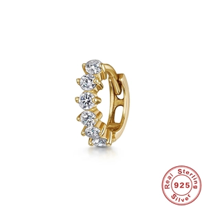 Macro view of gold S925 sterling silver hoop earring featuring six white cubic zirconias