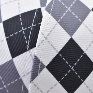 Macro shot of diamond pattern fabric and white stitching on this baseball cap