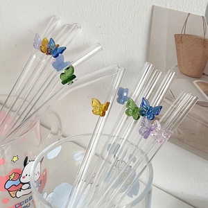 Heat-resistant glass straws with colorful butterfly accents in glass cups