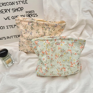 Detailed view of floral canvas makeup bags with lace embroidery and zipper closure