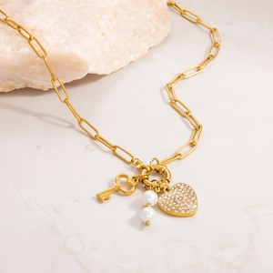Gold paperclip chain necklace with pearl accents and sparkling rhinestone heart pendant