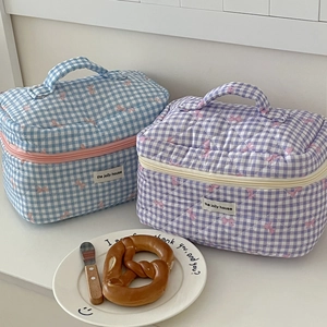 Quilted checkerboard makeup bags in blue and purple with pink bow and ribbon handles