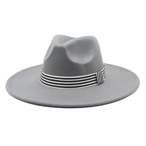 Detail of grey wool fedora hat featuring a stylish black and white striped decorative band