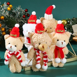 Mini plush Christmas teddy bears with red knit hats and scarves on festive decor tray
