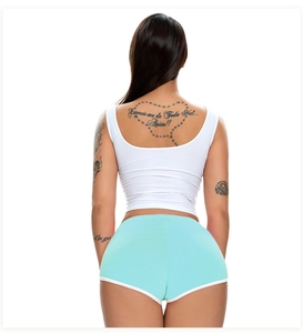 Rear view of mint green athletic shorts with white trim and a tight white tank top
