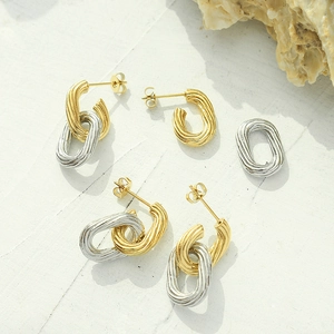 Textured oval hoop earrings set in twisted gold and silver finish stainless steel