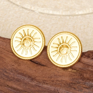 Macro shot of 18k gold plated stainless steel sun face stud earrings on wood