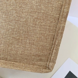 Close-up of natural linen bag showing reinforced stitching and weave texture detail
