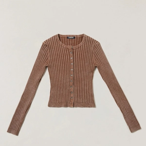 Macro view of brown ribbed knit cardigan featuring branded neck label and round buttons