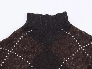 Detail of high-neck brown knit sweater with a classic diamond argyle pattern texture