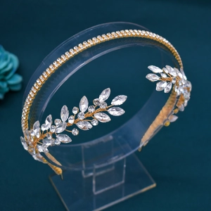 Detailed macro of golden bridal headband with marquise rhinestones and leaf design