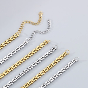 Detailed macro view of U-shaped chain links with polished gold and silver steel finish