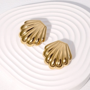 Elegant gold shell-shaped stainless steel stud earrings on a white minimalist display