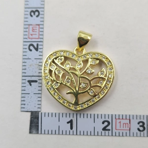 Detail of golden heart tree of life pendant showing 2.3cm by 2.5cm size measurement
