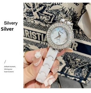 Close-up of luxury women's watch with ceramic strap and crystal bezel on wrist