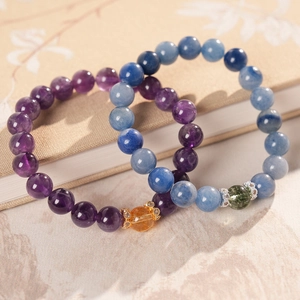 Close-up of beaded crystal bracelets with amethyst beads and elegant metal accents