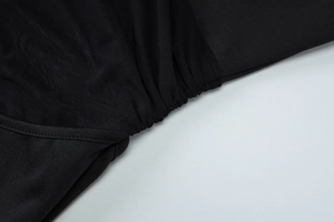 Detailed macro view of black mesh fabric stitching and shirring on summer dress