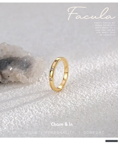 Macro detail of 18K gold plated ring with three zircons and fine textured band