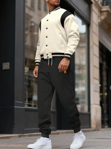 Outdoor street view of a men's varsity baseball jacket set with contrast color paneling