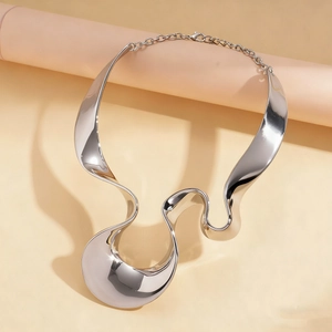 Macro view of silver liquid metal necklace with irregular geometric twisted design