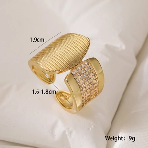 Macro shot of 18K gold plated wide ring with wavy texture and shimmering zircon inlay