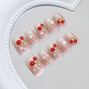 Pink cat-eye press-on nails with 3D cherry and silver star charms in a sweet style