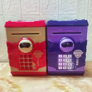 Detail showing red and purple electronic toy money safes with keypads and money slots