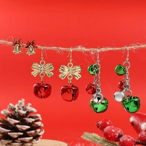 Christmas bell earring set with Santa trees and bows on a festive red background