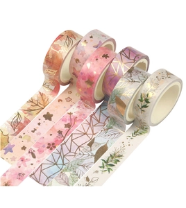Detail of 5 rolls of gold-stamped Washi tape with floral and geometric patterns