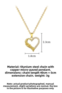 Detail of gold heart pendant featuring sparkling micro-pave crystals and feather texture