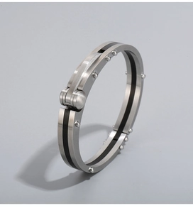 Detail of titanium steel bangle with carbon fiber inlay and mechanical rivet buckle