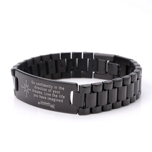 Detail of black stainless steel ID bracelet with compass and graduation quote engraving