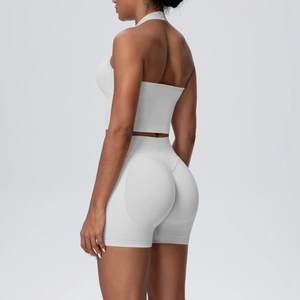 Side view of white ribbed yoga set featuring a halter top and high-waist lifting shorts