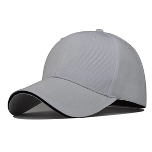 Detail of white polyester baseball cap showing sandwich brim and ventilation eyelets