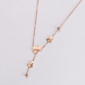 Detailed view of rose gold stainless steel heart pendants with radial texture on a necklace
