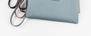 Close-up of premium leather wristlet wallets showing fine stitching and multi-color texture