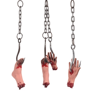 Realistic severed limbs props with bloody details hanging on rusty metal chains for Halloween