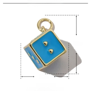 Macro shot showing blue enamel dice pendant dimensions 13mm by 20mm in copper gold