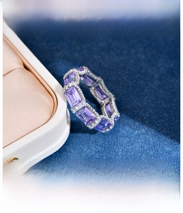 Detail of S925 silver ring featuring emerald cut purple stone with micro-pave setting