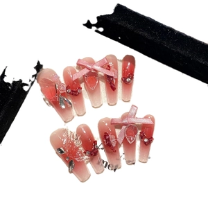 Pink gradient long coffin press-on nails with 3D bows, heart rhinestones, and floral charms
