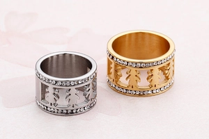 Macro view showing silver and gold cutout girl rings with sparkling rhinestone accents