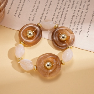 Detailed macro of vintage resin and alloy beaded necklace with gold accents
