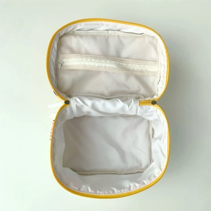 Inside view of yellow bear quilted makeup bag with zipper pocket and white lining