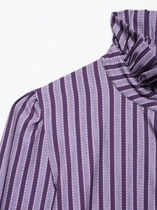 Detail of purple striped polka dot blouse with ruffled collar and puff shoulder design