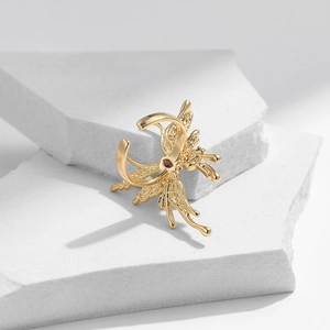 18K gold plated butterfly open ring with red zircon stone on white textured stone base