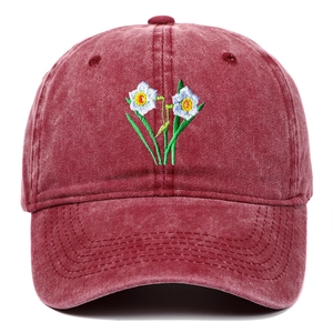 Close-up of vintage washed cotton baseball cap with intricate narcissus flower embroidery