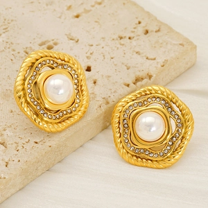 Vintage gold stud earrings with a central pearl surrounded by zircon stones and twisted metal